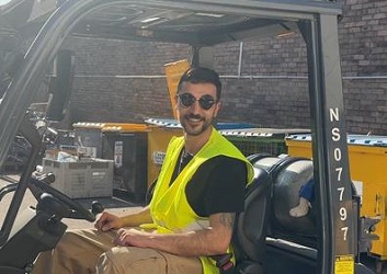 photograph of a man on forklift