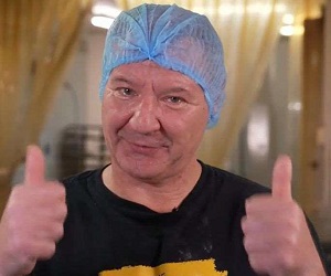 photograph of a man with both thumbs up