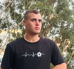 photograph of a man leaning on a fence