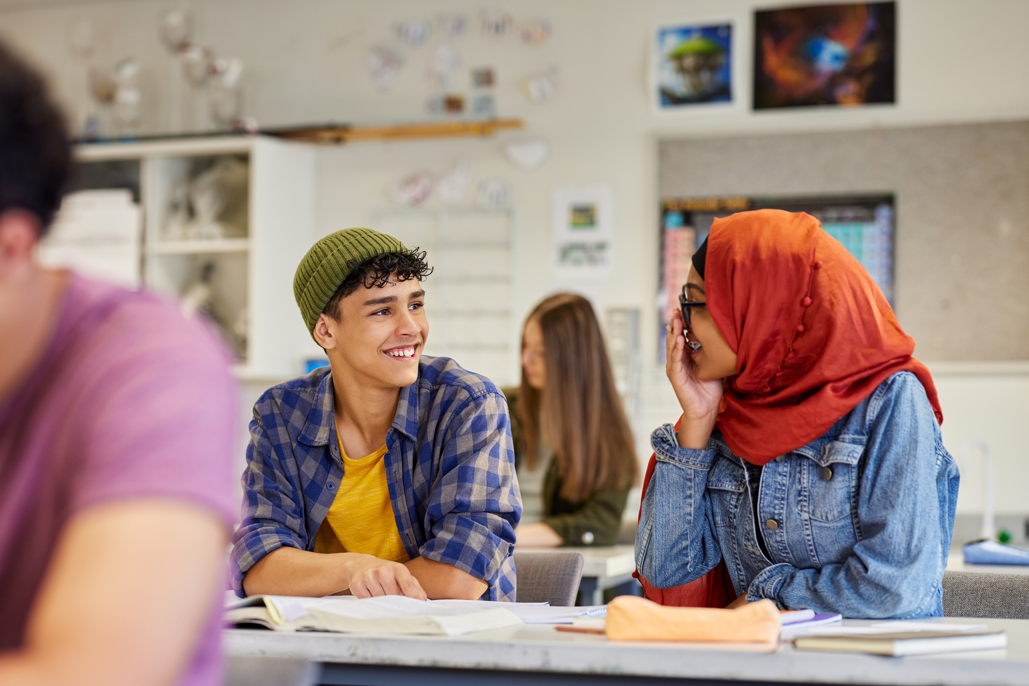 two students talking to each other in class